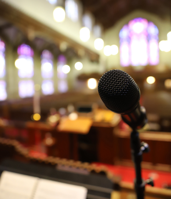 microphone with blurred church pews in the background